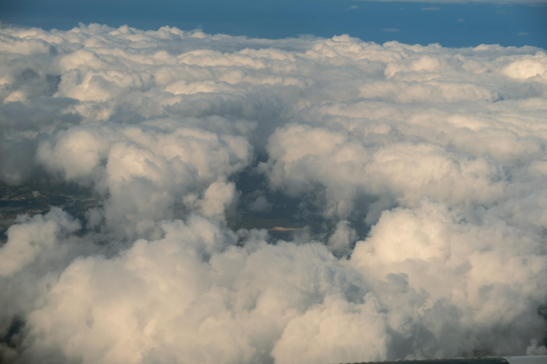 Stunning aerial view of cumulus clouds from above, showcasing fluffy cloud formations.